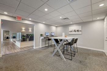 A conference room with a table and chairs.